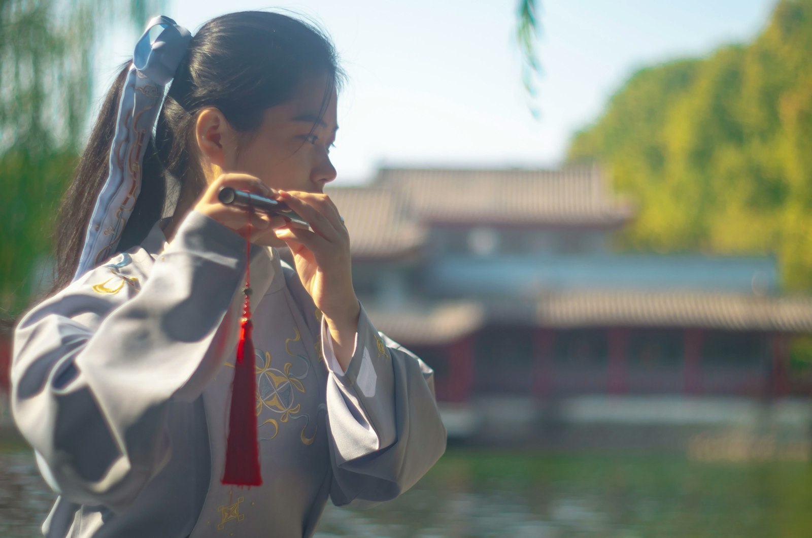 A Chinese woman playing a flute.