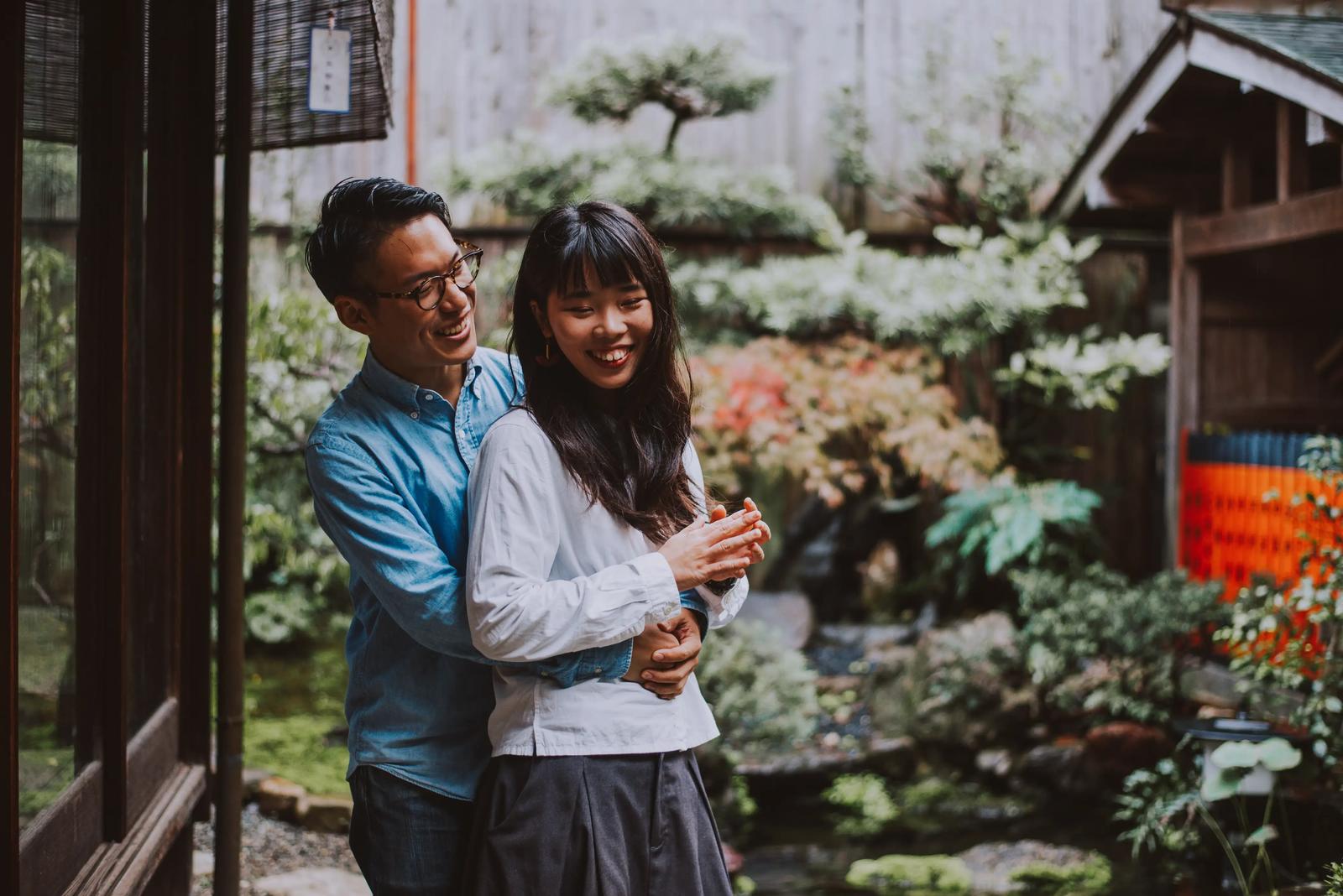 A young Japanese couple embracing.