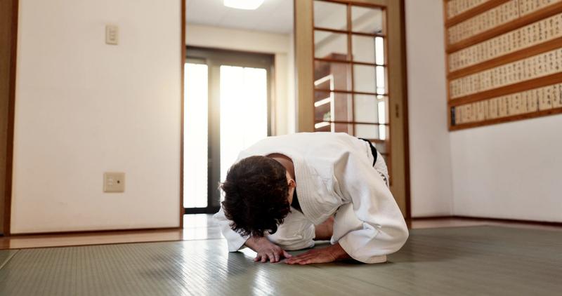 A Japanese martial artist bowing, expressing his thanks.