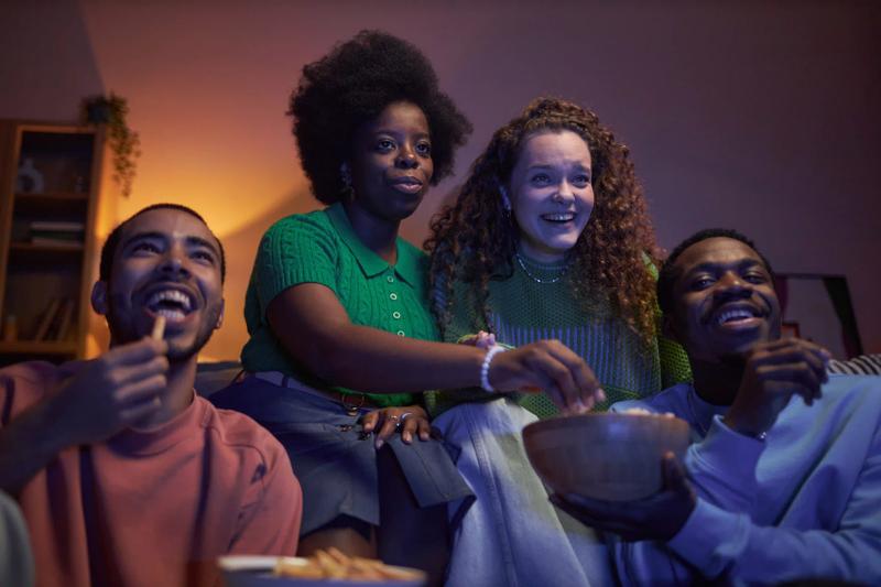 A group of friends gathered on the couch, watching something Netflix—perhaps a classic j-drama!