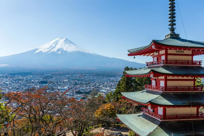 A photo of a Japanese temple with Mount Fuji in the background