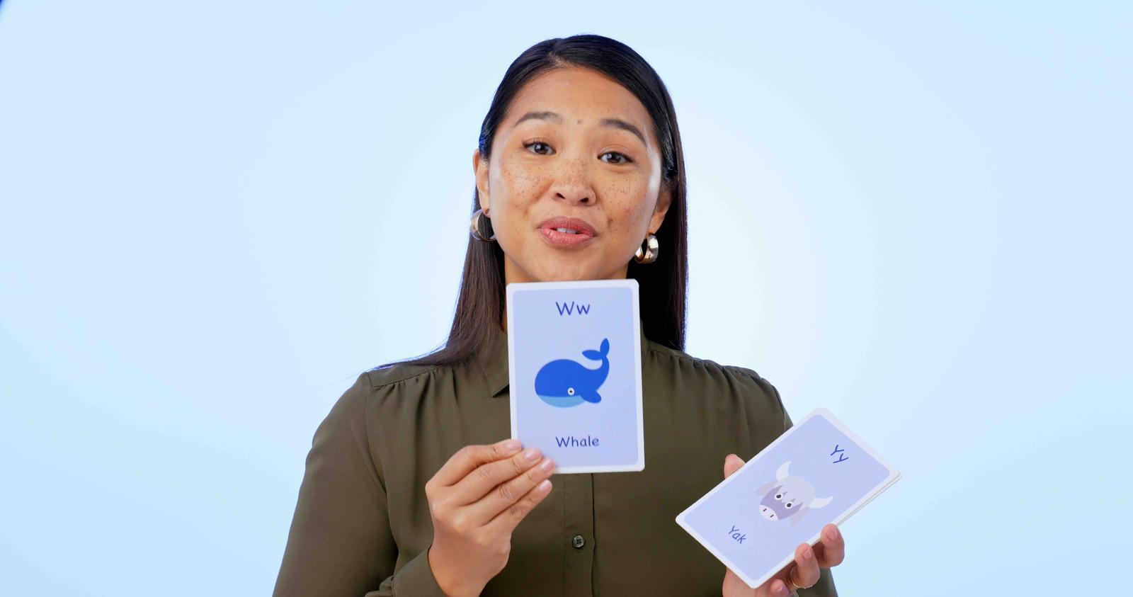 An Asian woman holding up a flashcard, about to explain how much better modern tools like Migaku are for learning vocabulary!