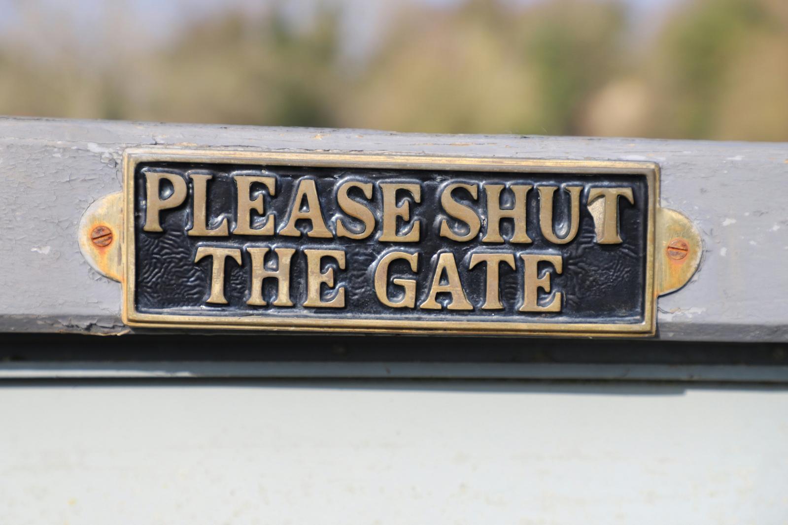 A gate with a 'please shut the gate' sign on (Unsplash: Dave Lowe)