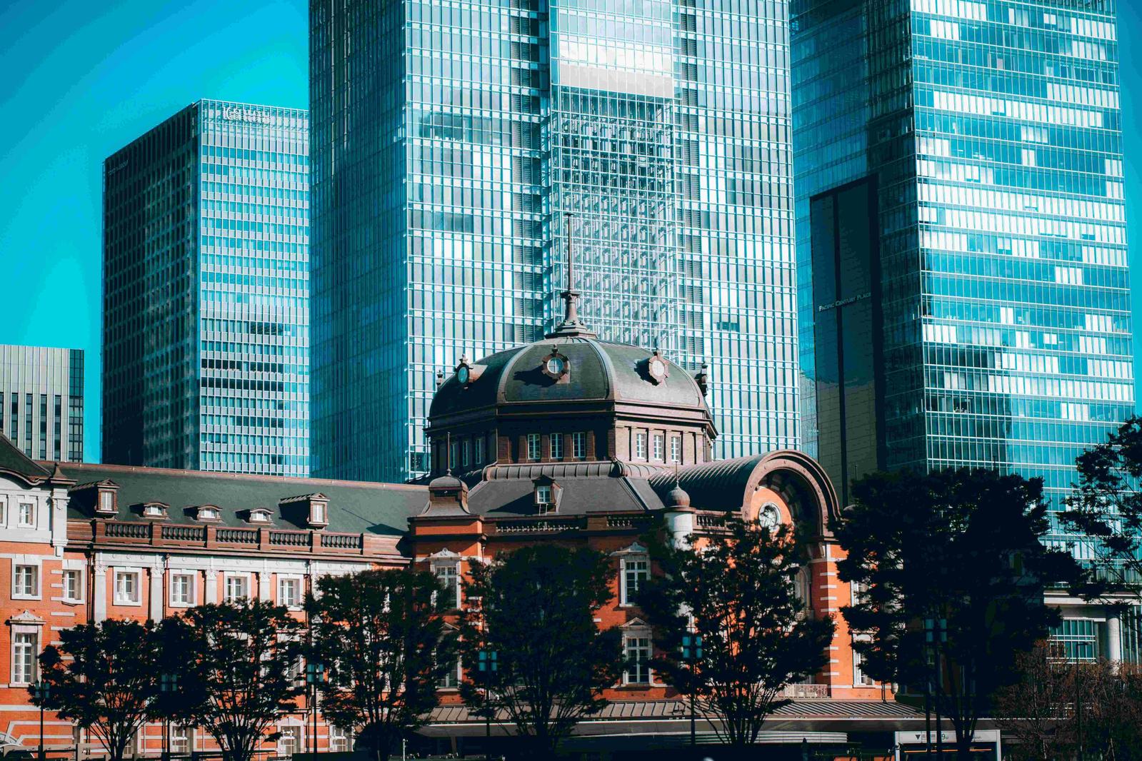 The traditional exterior of Tokyo Station set against modern Tokyo