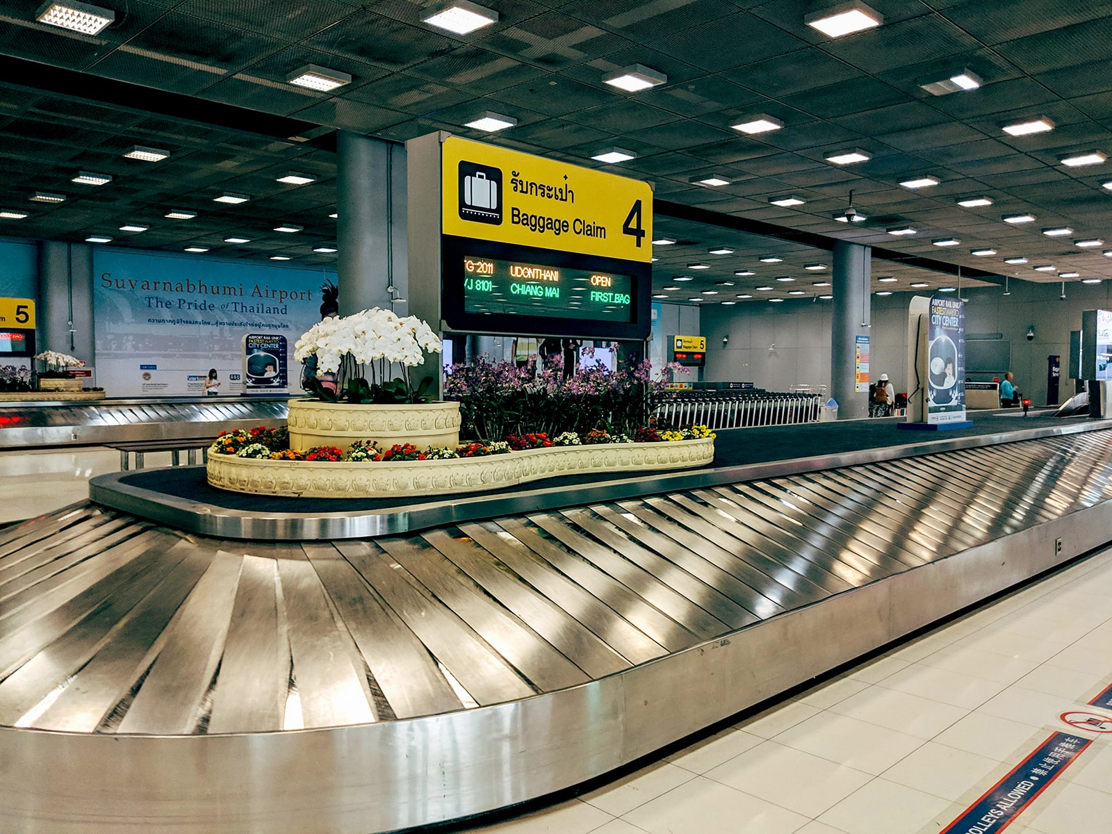 A photograph of a baggage claim carousel, such as you'd find in the arrival portion of an airport terminal