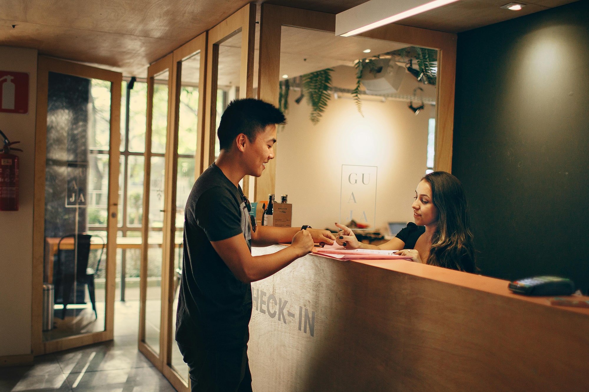 A screenshot of a man checking into a hotel while speaking English