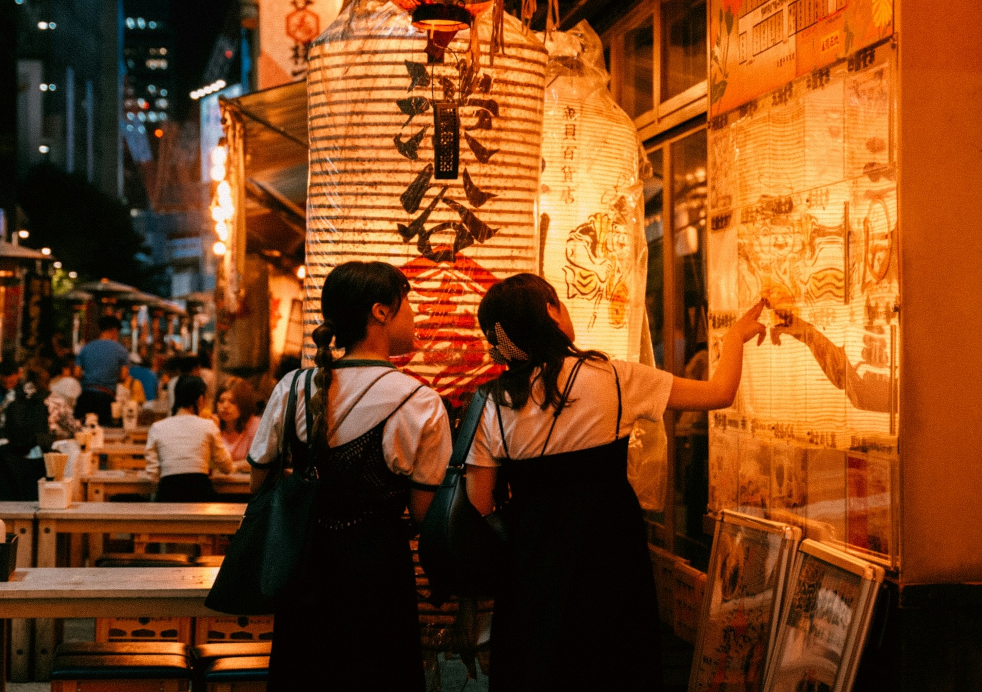 Two Japanese girls out at a festival, likely close enough to refer to each other as -chan 