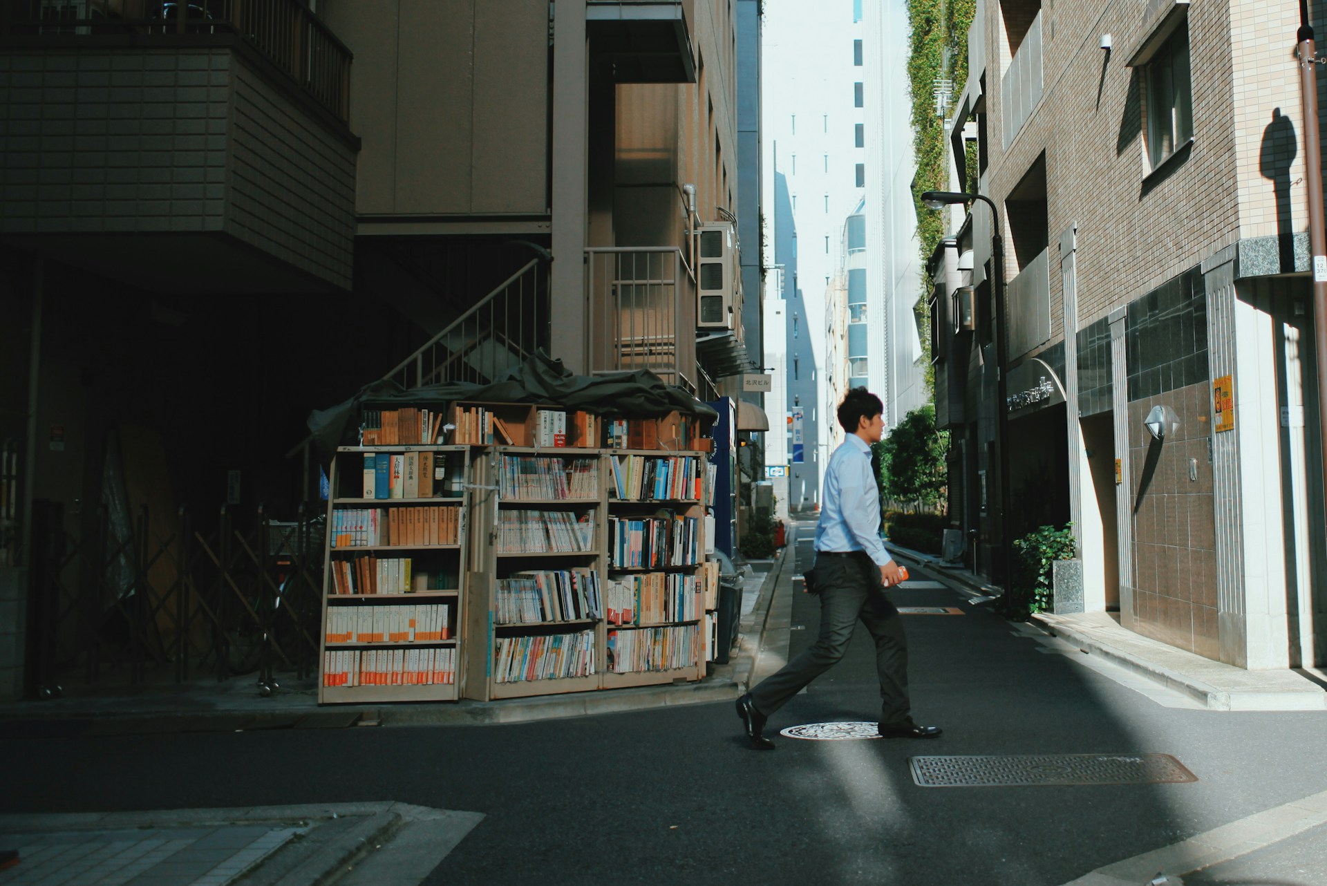 A screenshot of a guy walking past a bookshelf, just like we're moving onto a discussion about Japanese reading strategies